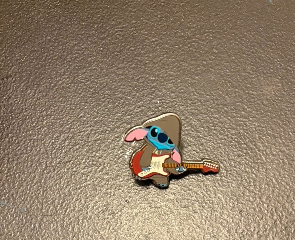 Disney Pin Stitch in a hoodie playing the guitar